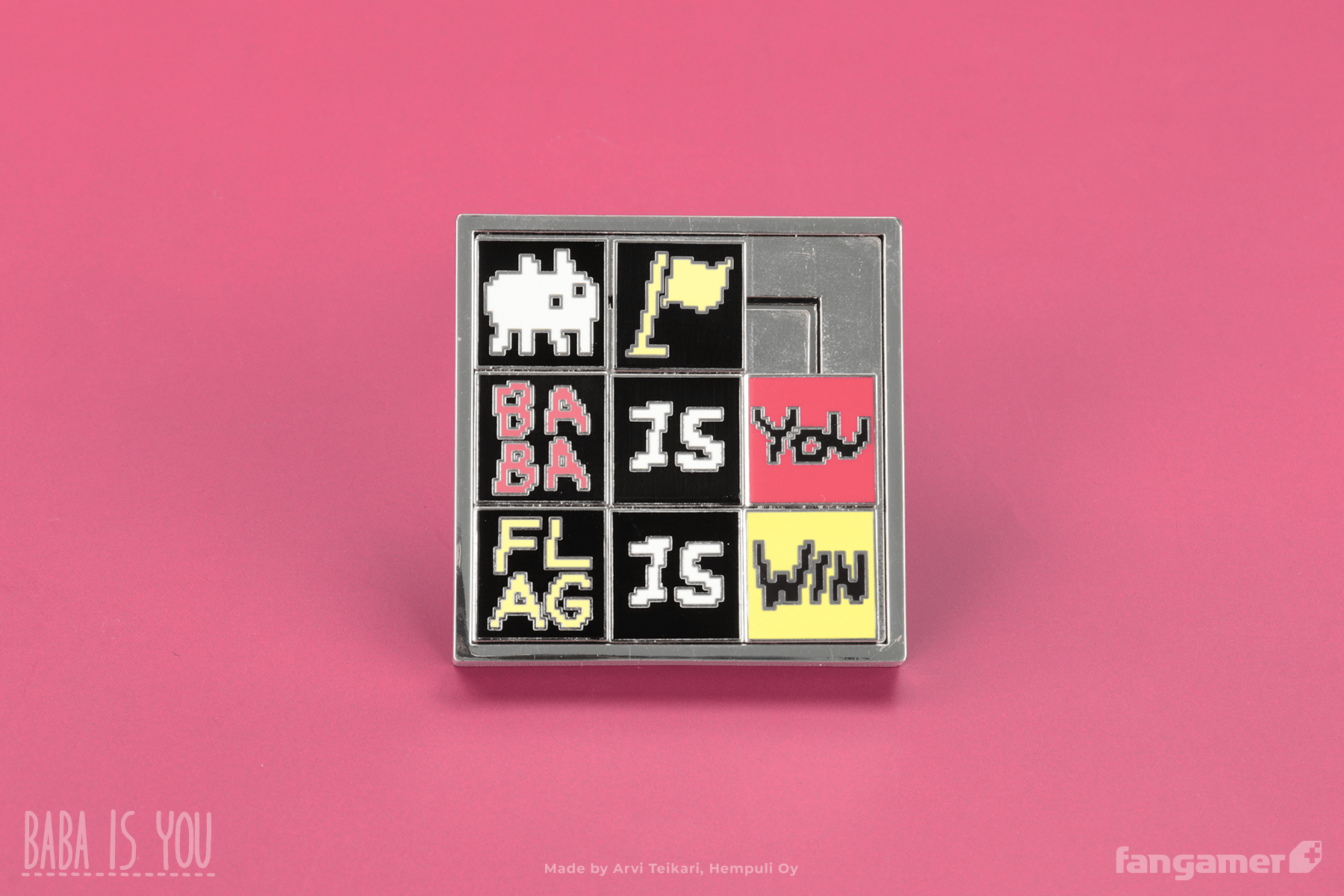 A closeup photo of Baba Is Pin, showing that it's a functioning sliding puzzle. From the top left, the squares are currently (Baba), flag, blank, BABA, IS, YOU, FLAG, IS, WIN. 