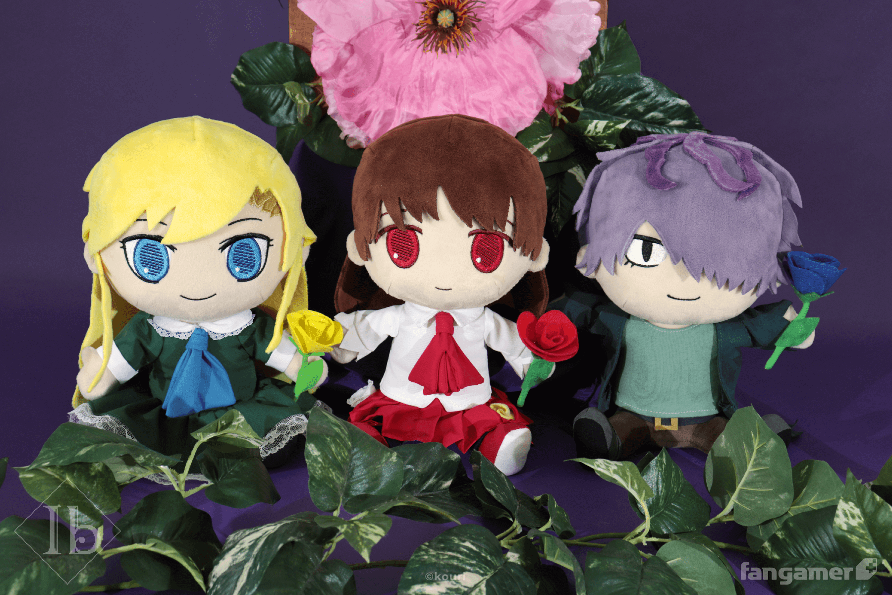 The Mary plush, Garry plush, and Ib plushes, each holding their magnetic rose accessories and photographed in front of a leafy plastic plant and a large pink flower. All three featured embroidered face details and multilayer clothing. 